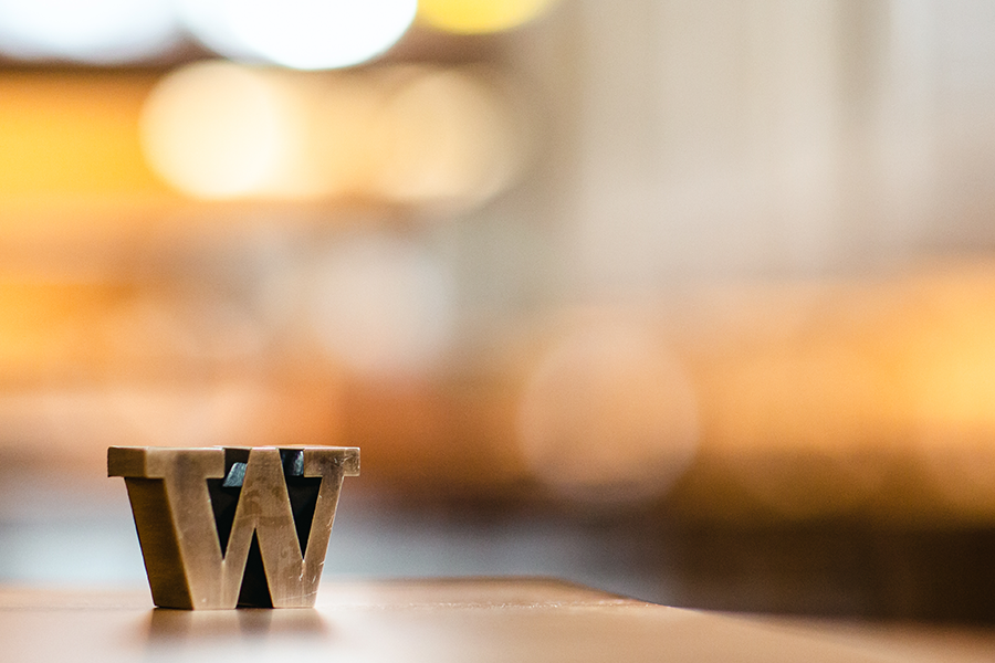 The letter W on table with blurred background