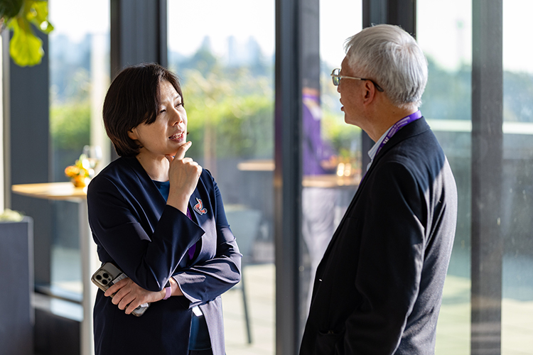 Two people speaking at event