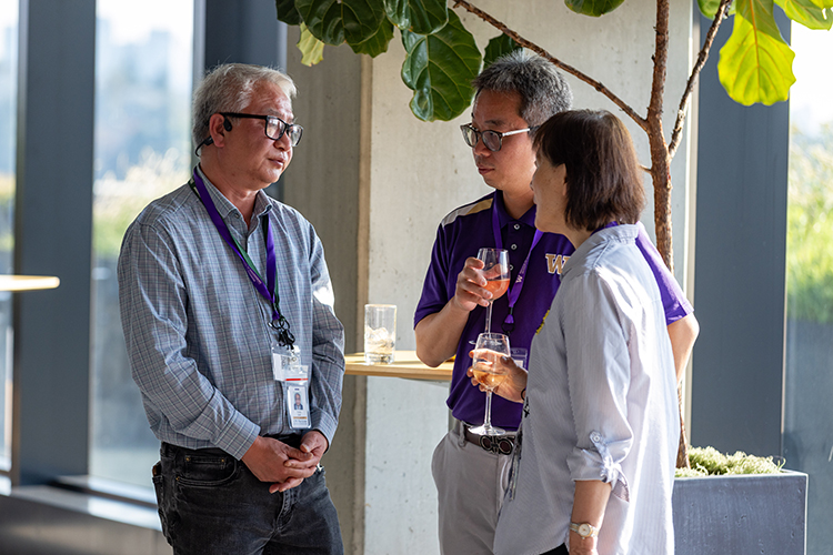 Three people standing and talking