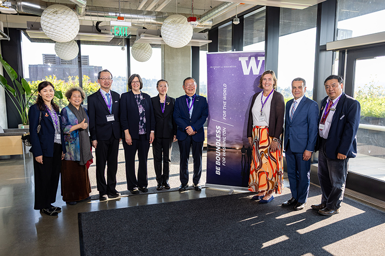 Group photo next to UW sign